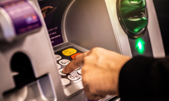 man using an ATM