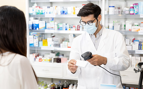 Pharmacist scanning a prescription